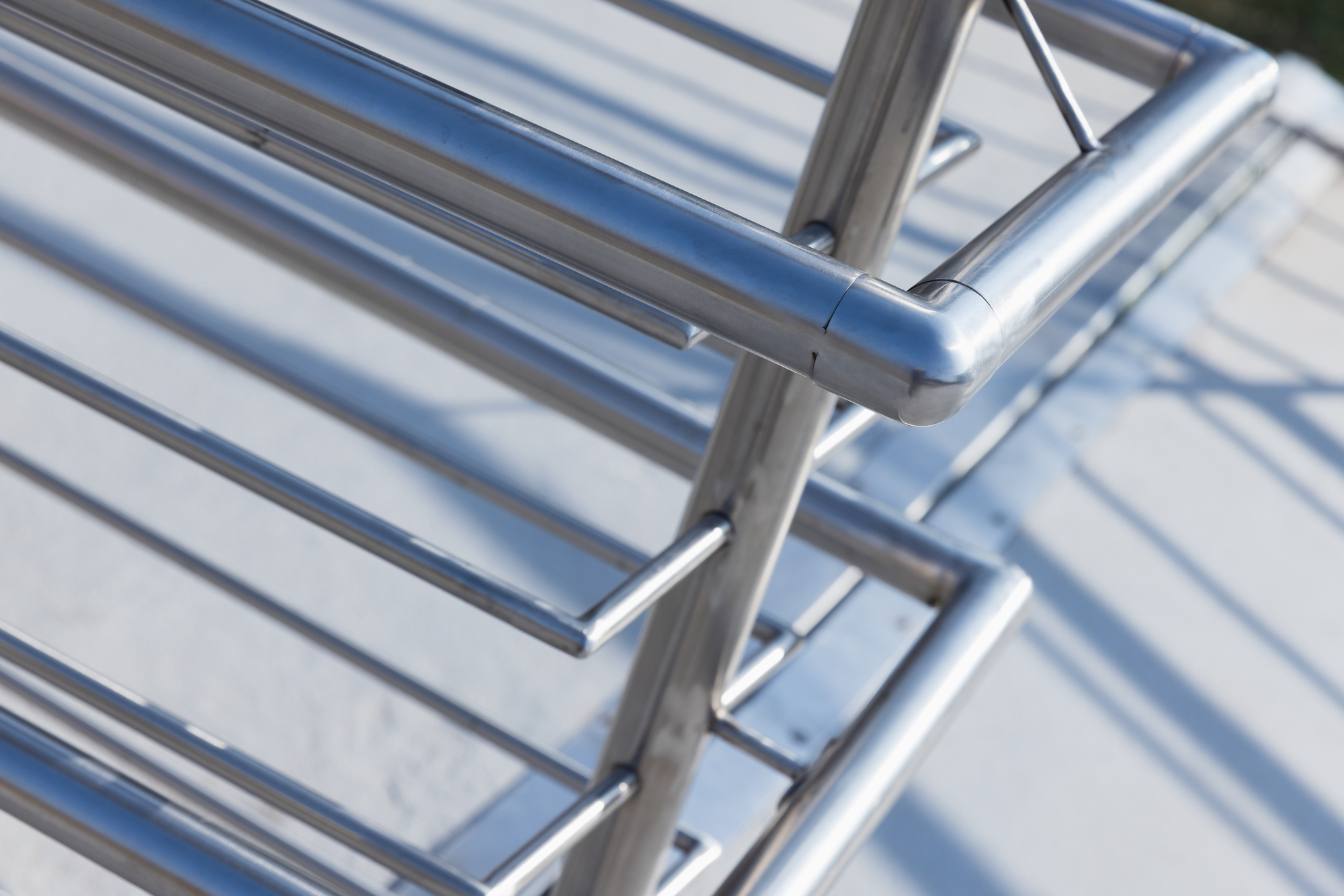 Close-up of a polished stainless steel railing and handrail